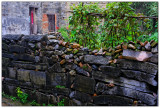 9 House Village, wall made of gravestones