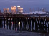 An old wooden pier,with the grandeur of Canary Wharf,behind