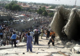 Pakistani volunteers work at a collapsed building following an earthquake in Islamabad.jpg