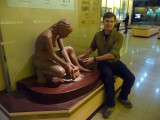 Me pretending to make pottery with this replica of an ancient Vietnamese woman.
