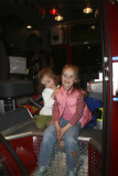 Madison and Faith posing in the shiny new pumper truck
