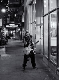 musician in front of OTB Midtown bw