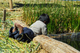 Uros boy playing alongside the fish pen