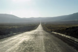 Straight road across the Altiplano headed into the sun