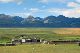 Sturdy rural Tibetan dwelling on the edge of the vast plain