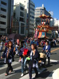 Locals in traditional dress leading a float