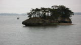 Island in the bay with passing boat