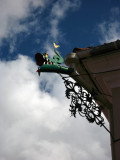 Metal dragon ornament jutting off a building