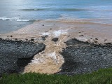 sand washing out to sea after the storm