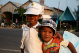 Childrens offering their services to slide on the sand of the magnifiques dunes of Mui Ne, Vietnam