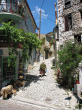 Woman walking up narrow street in Agiassos, Lesvos