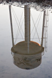 Former (as in not used anymore) water tower reflected on surface water