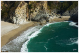 80-foot waterfall dropping from cliffs into the ocean