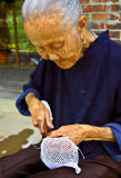 0293 Village elder making netting.