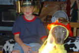 This is our grandson Reece in his daddys fireman helmet with Reba in her firemen outfit