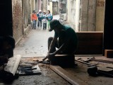 Woodworker in the light of his doorway