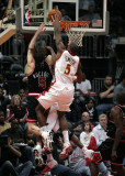 Andres Nocioni attempts to grab a rebound with Smith defending