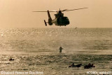 Late 80's - USCG HH-65 #6525 hoisting Coast Guard Reserve air crew members during wet drill