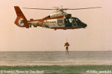 Late 80's - USCG HH-65 #6525 hoisting Coast Guard Reserve air crew member during wet drill