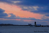 Sunset over a snow covered farm