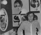 Santilli standing in front a collage of  Vidal Sassoon work from the other day