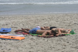 michael and alex asleep on the beach