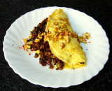 omelete with saueed mexican style soya protein, onions, peppers, chili, cumin, cacao & more, topped with walnuts