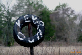 YOU USE AN OLD TIRE AS A KEEP OUT SIGN.