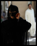 Woman wearing traditional mask - Nizwa