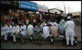 Men gathering at the market place - Mutrah
