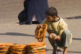 Kid selling enormous bread things