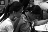 Two market Girls reading the lottery results