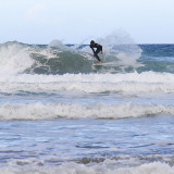 surfing at Porthtowan in difficult cross breakers at low tide