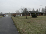 Driveway view of house  & shop