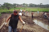 Assisting a farmer build a pond.JPG