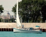 sailing past a seawall guarding moored boats on the Chicago waterfront