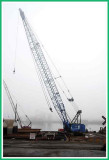 Mobile crane on a foggy river.