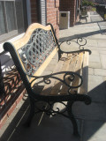 sun and shadows on bench outside millington savings bank.