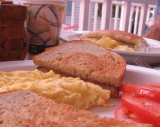 scrambled eggs, toast and tomatoes
