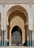Morroco -- riding a bike in front of the mosque