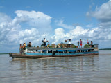 Riverboat loaded with people and cargo