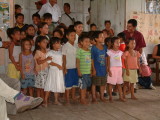 Children at a school singing como estas