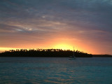 The sun sets behind Ovalu Island and sets the stage for a fantastic light show