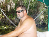 CAPTAIN DON EASES THE BOAT THROUGH A CANAL TO THE HOMOSSASA RIVER
