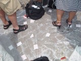 THE DISCARDED RACE TICKETS CUSHIONED THE CRACKS OF THE COBBLESTONES