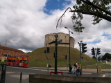 A tourist signpost,with Clifford's Tower,behind.