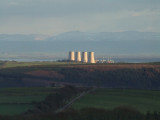 Late afternoon sunlight illuminates the cooling towers at Chapelcross.