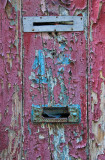 The mail slots in the old red wooden door