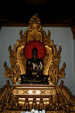 A Buddha in the prayer hall of Atumashi Monastery.  Note changing electric lights of the halo.