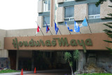 Sign for the Honduras Maya Hotel with flags.